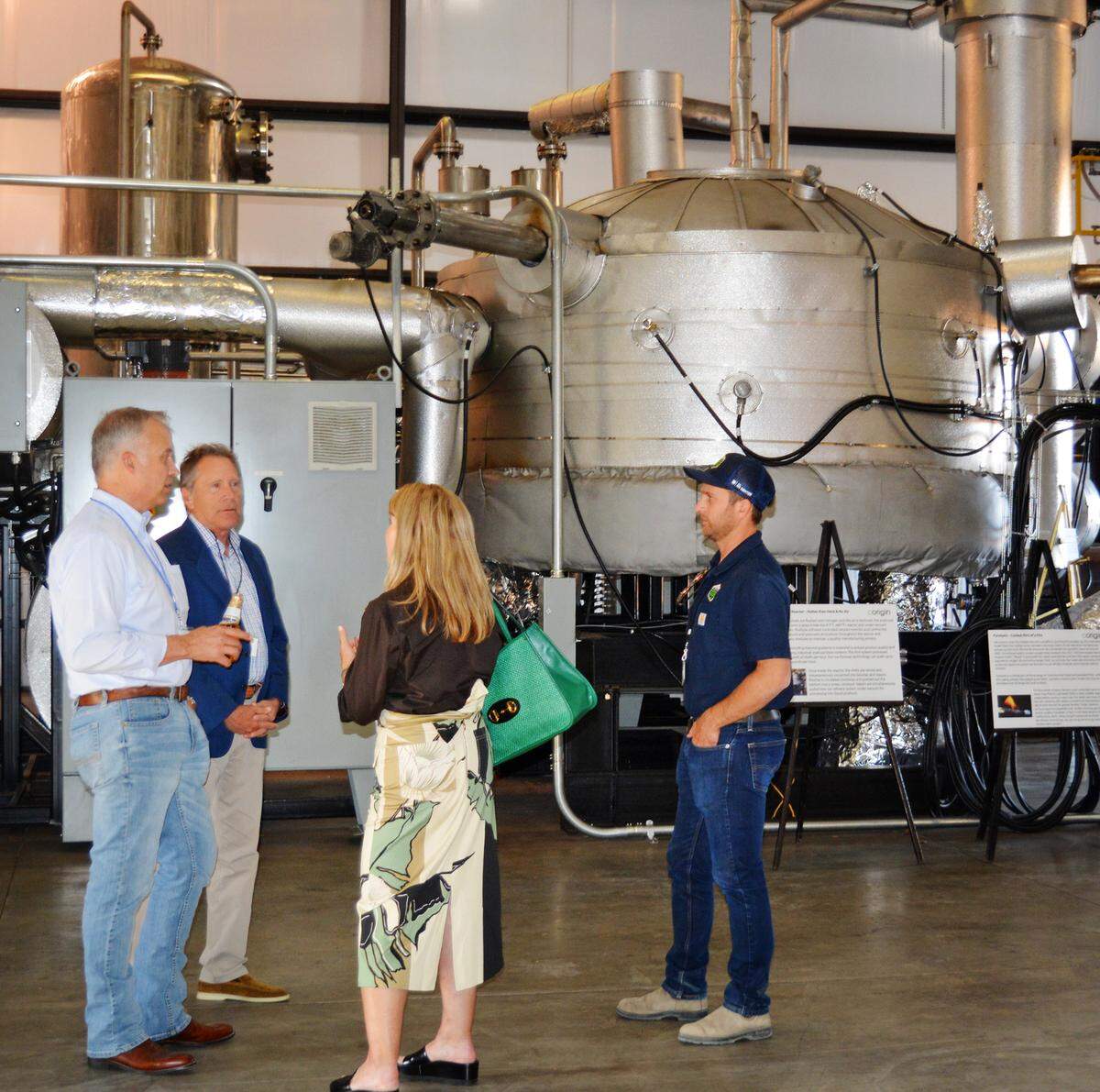 Corigin Solutions CEO Mike Woelk, left, hosted tours on Sept. 28, 2021, at the Merced CA plant where it turns almond shells into especially rich fertilizer.
