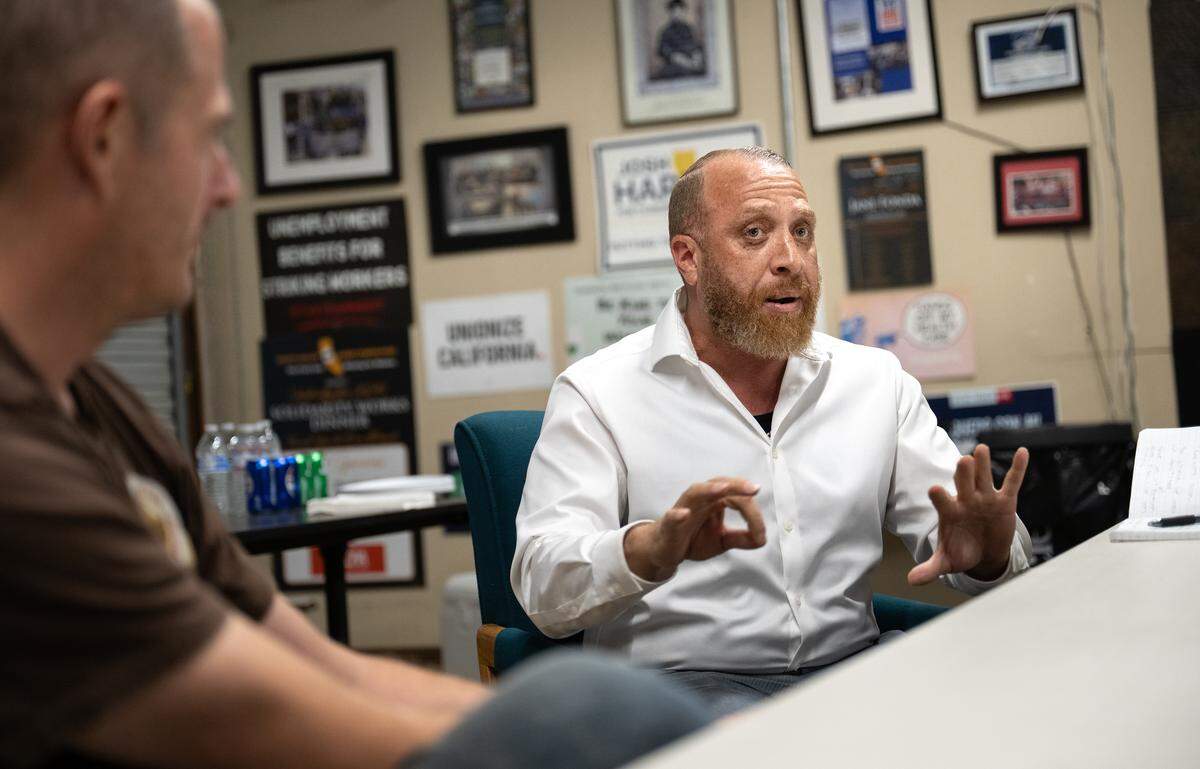 Food server Michael Williams, right, is organizing employees of BJ’s Restaurant to establish a union at the Modesto location at Vintage Faire Mall. Williams is seen here with North Valley Labor Federation Executive Director Will Kelly in Modesto on  Tuesday, Sept. 9, 2025. 