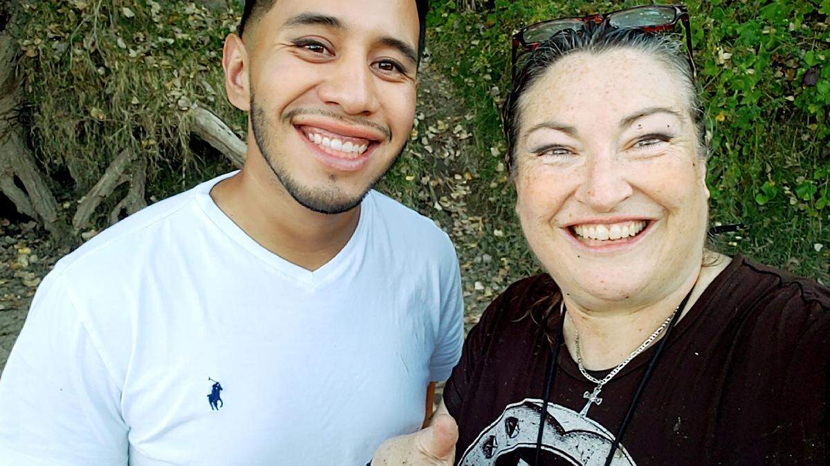 Chanda Benson takes a photo with Gerardo Hernandez shortly after he helped rescue her and her dog from the Stanislaus River on Wednesday, Oct. 25, 2018.