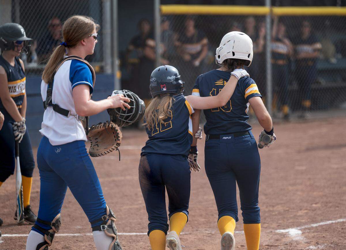 Big Valley’s Olivia Nelson (12) hugs teammate Ava Hernandez (15) after they both scored the first of the Lions five runs in the CIF NorCal Softball Championship game with Los Altos at Big Valley Christian High School in Modesto, Calif., on Saturday, June 4, 2022. Big Valley won the game 5-3.