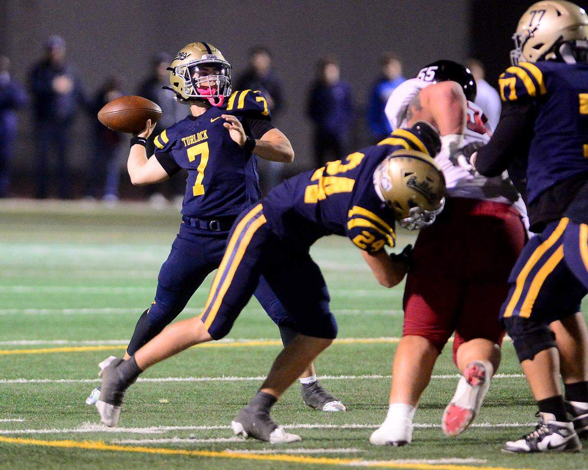 Turlock quarterback Scout Silva (7) throws a deep pass during a Division 1 CIF San-Joaquin Section playoff game between Turlock High School and Laguna Creek High School at Turlock High School in Turlock California on November 8, 2024. Turlock won the game 48-12.