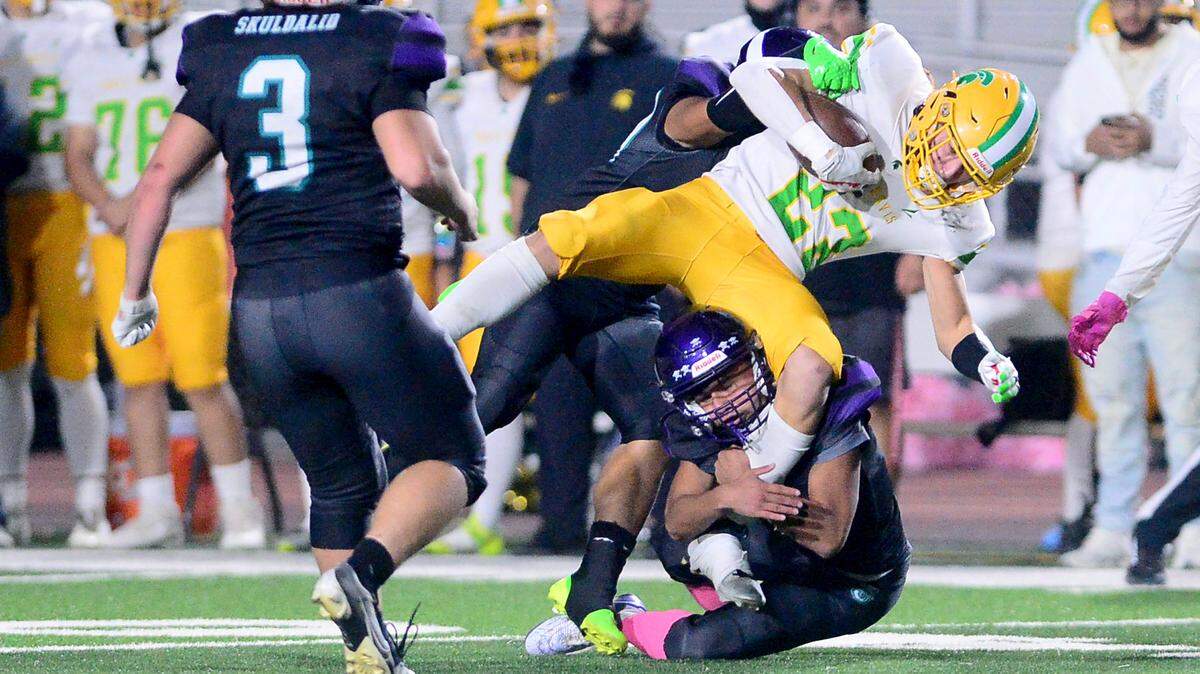 Davis running back Ezekiel Suarez (23) gets taken down by multiple Johansen defenders during a game between Johansen and Davis at Johansen High School in Modesto California on November 1, 2024.