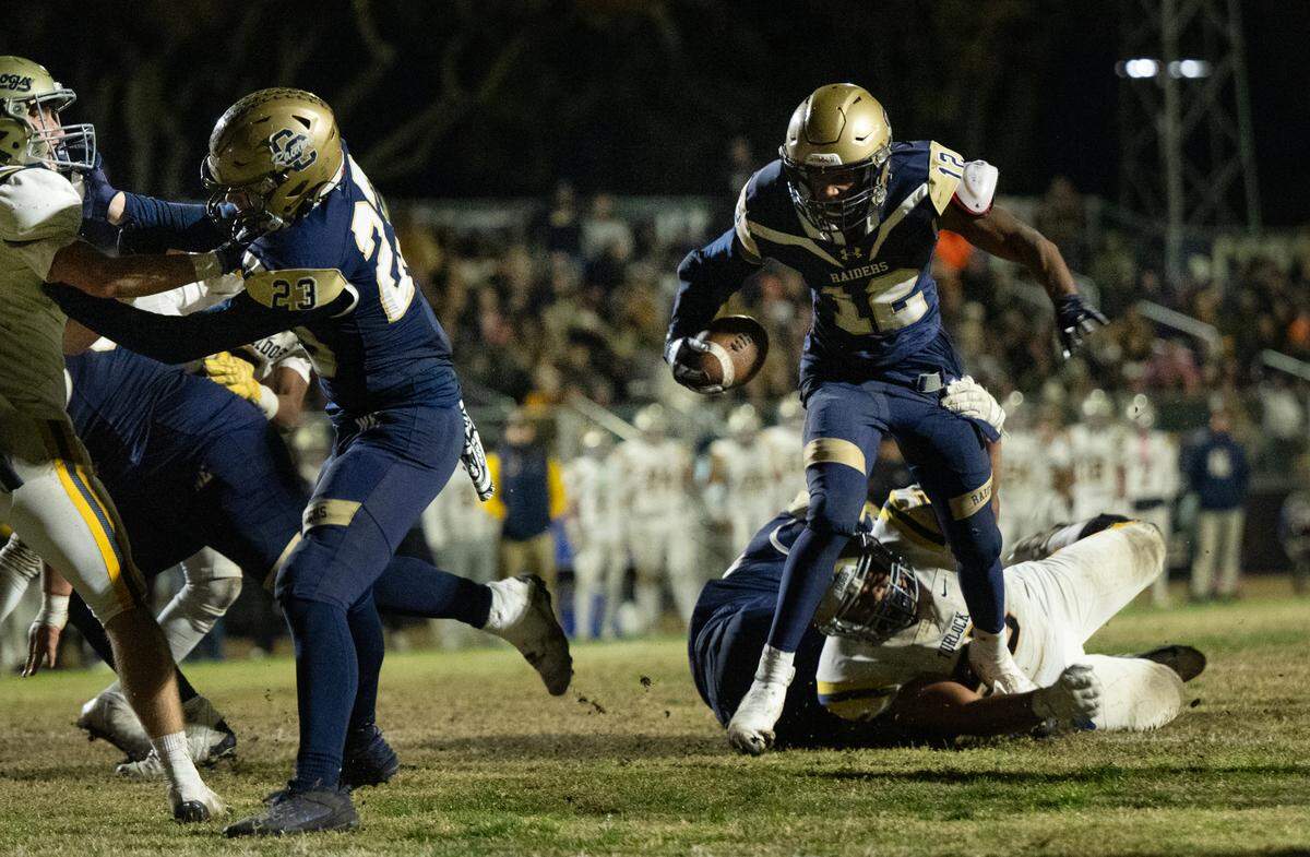 Central Catholic’s Joey Alcutt slips a tackle during the Sac-Joaquin Section Division I playoff game with Turlock at Central Catholic High School in Modesto, Friday, Nov. 15, 2024.