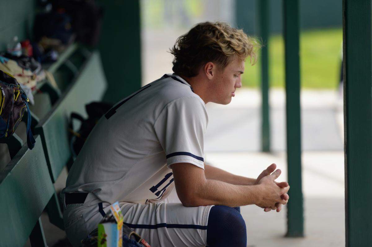 Central Catholic’s TP Wentworth sits in the dugout in the top of the second inning during a Valley Oak League matchup with Manteca at Manteca High School on Friday, April 26, 2024.