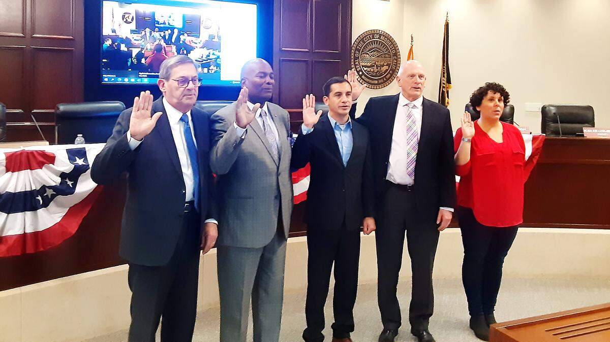 From left, Nick Bavaro, Jeremiah Williams and Eric Alvarez take the oath of office Tuesday, Nov. 29, 2022, at Tenth Street Place. Chad Brown and Jolene Daly also take the oath after being elected to the Modesto City Schools board.