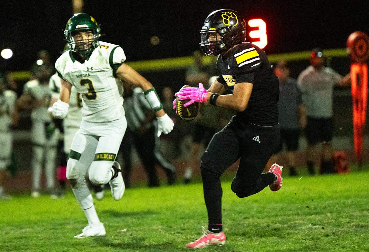 Hughson’s Lawson Aviles runs after a catch during the Trans Valley League game with Sonora in Hughson, Friday, Oct. 11, 2024.