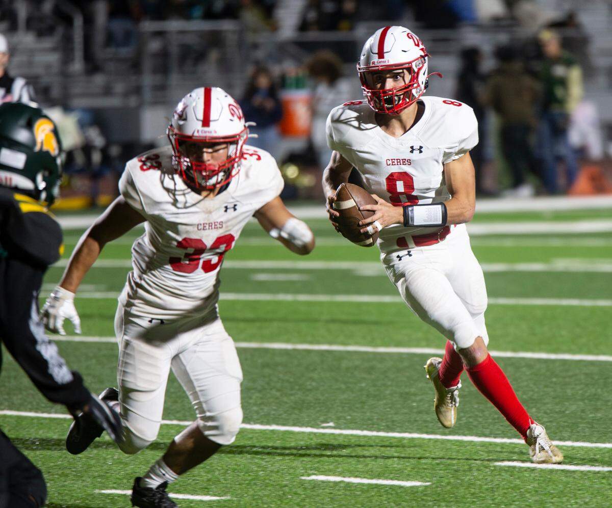 Donovan Osuna, 8, of Ceres High gets protection from teammate Isaac Vizcarra, 33, as he looks up field for an open man during a WAC game against Davis High on Friday Oct. 27, 2023.