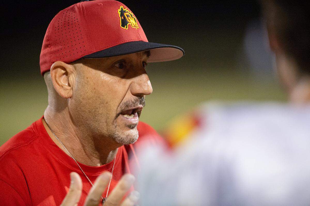 Oakdale head coach Trent Merzon talks with players on the sideline during the Valley Oak League game with Central Catholic in Modesto, Calif., Friday, Oct. 14, 2022.