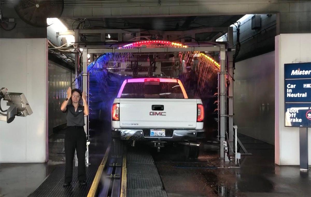A customer service advisor guides a vehicle at Mister Car Wash Friday afternoon October 25, 2019 on McHenry avenue in Modesto, Calif.
