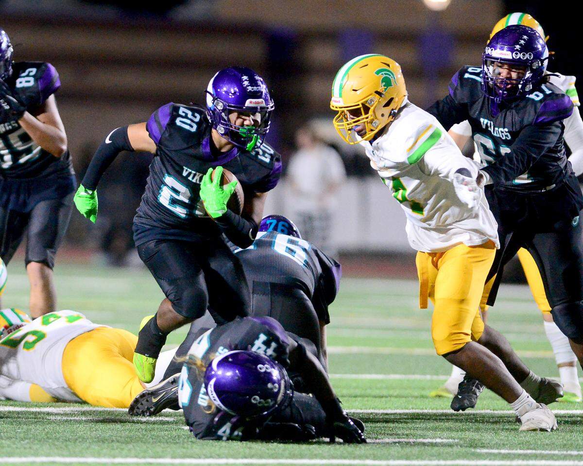 Johansen running back Kean Saing (20) braces for impact during a game between Johansen and Davis at Johansen High School in Modesto California on November 1, 2024.