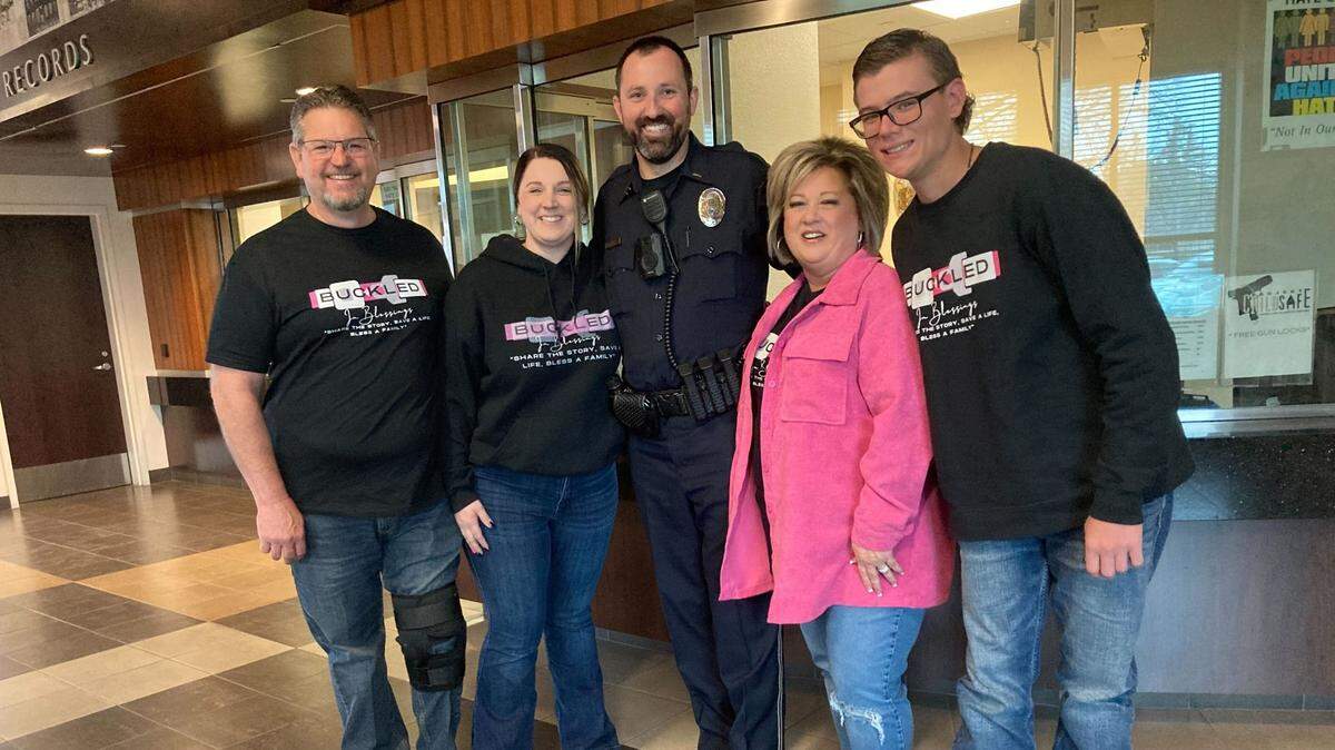 The Heilman/Scott family visits the police officer who pulled over Megann Scott for not wearing her seat belt on Feb. 27, 2013. The ticket and fee saved her life. Left to right: John Heilman, Megann Scott, Turlock Police Officer Joseph Dusel, Monika Heilman, Michael Heilman.