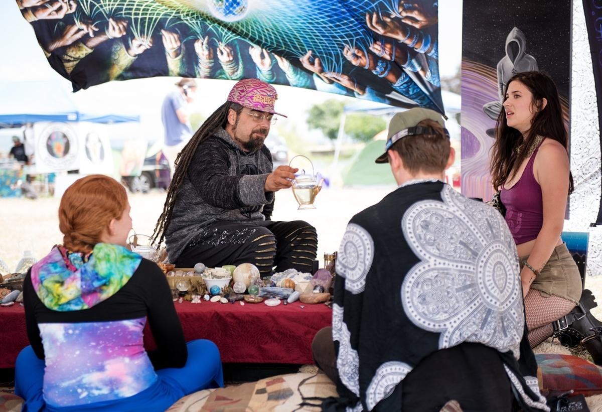 Ronjon of Nevada City hosts a tea party with white tea and freshly picked red clover during the Serenity Gathering at Woodward Reservoir in Oakdale, Calif., Saturday, April 28, 2018.