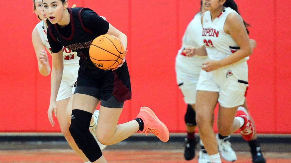 Riverbank guard Livi Fernandez (1) drives the ball up court after forcing a turnover during a game between Ripon High School and Riverbank High School at Ripon High School in Ripon California on Jan. 5, 2023.