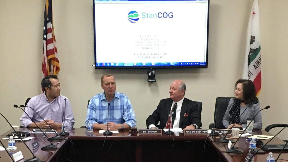 L-R, U.S. Transportation Under Secretary Derek Kan, Rep. Jeff Denham, Modesto Councilman Bill Zoslocki and Stanislaus Council of Governments Executive Director Rosa Park discuss local transportation projects in the StanCOG board room in Modesto, Calif. on Tuesday, Oct. 9, 2018.