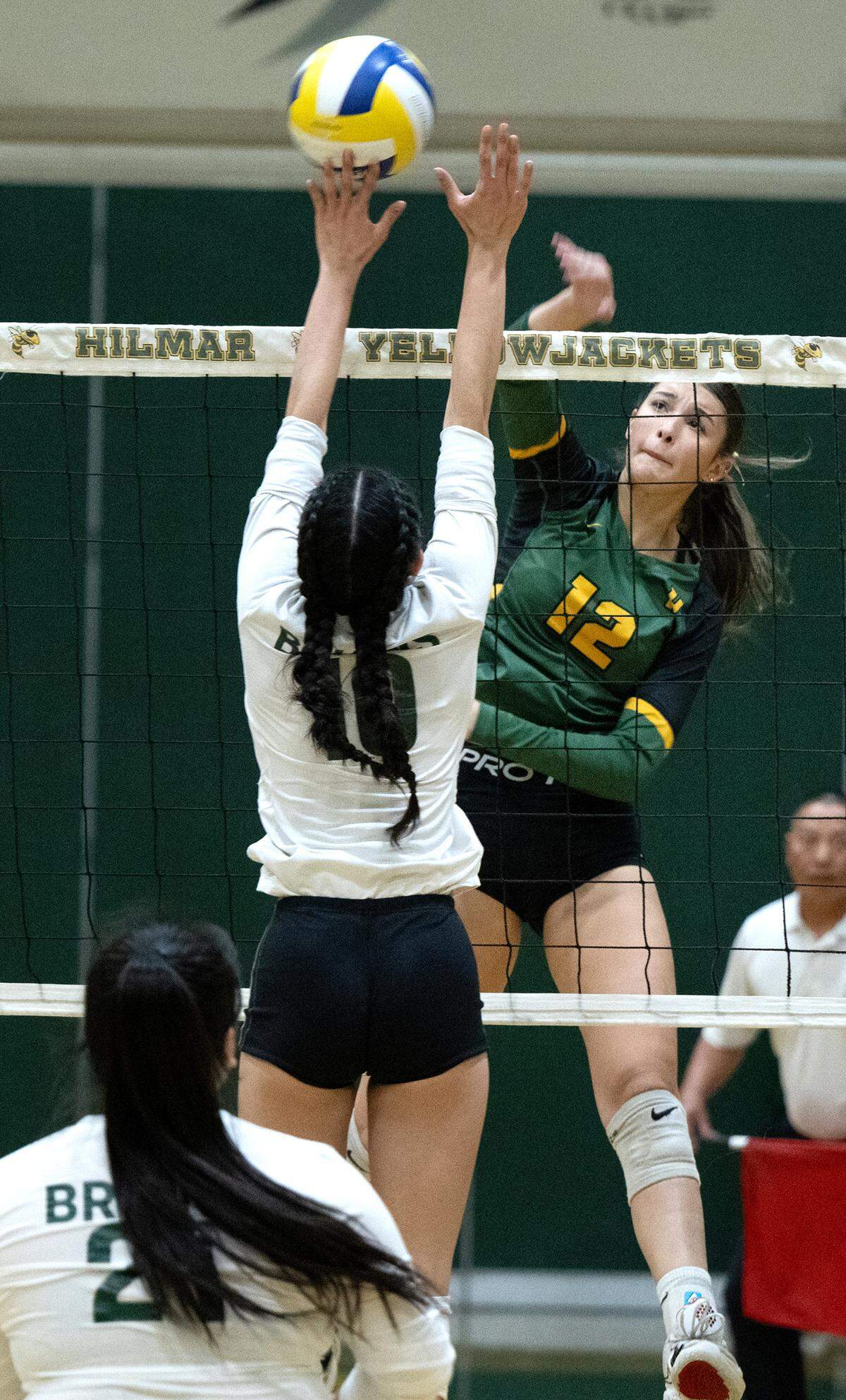 Hilmar’s Alyssa Colston spikes the ball past St. Patrick-St. Vincent defender during the CIF Northern California Division IV volleyball championship match at Hilmar High School in Hilmar, Tuesday, Nov. 19, 2024.