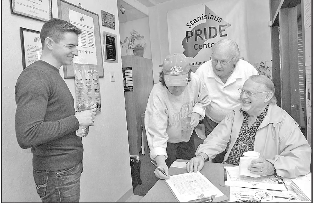 Keith Highiet, board president of the Stanislaus PRIDE Center, greets Carol Clayton, Mel Nomann and John Crabb as they sign the guest book at the center in 2007.