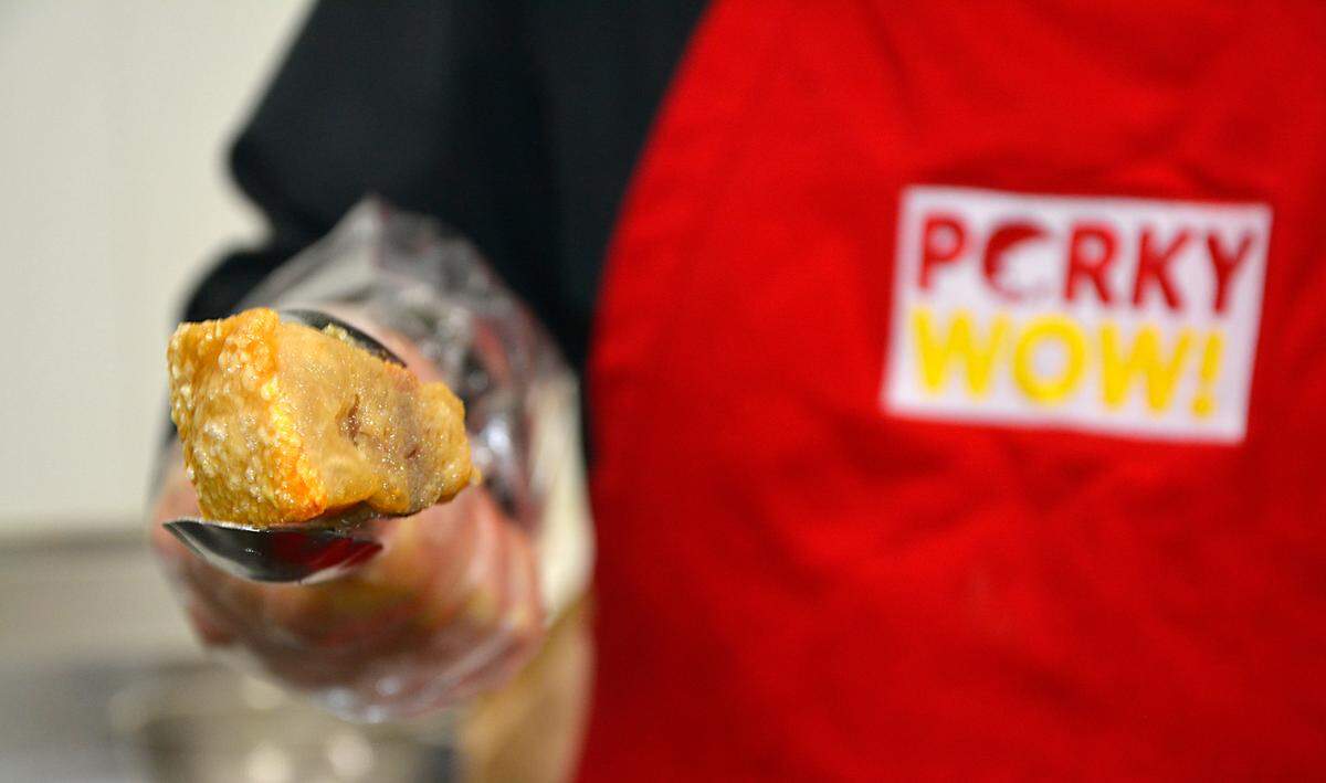 Fabricio Bernal, owner of Porky Wow, holds up one of his chicharrones in Turlock, Calif. Nov. 16, 2022.