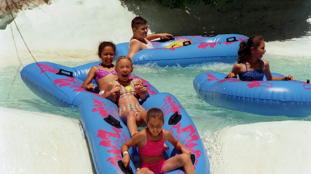 In this June 1999 photo, Kristy Coddle, 10, Vanessa Grijalvara, 10, and Felicia Grijalvara, 11, anticipate a drop in the Rapids ride at the Manteca Waterslides park.