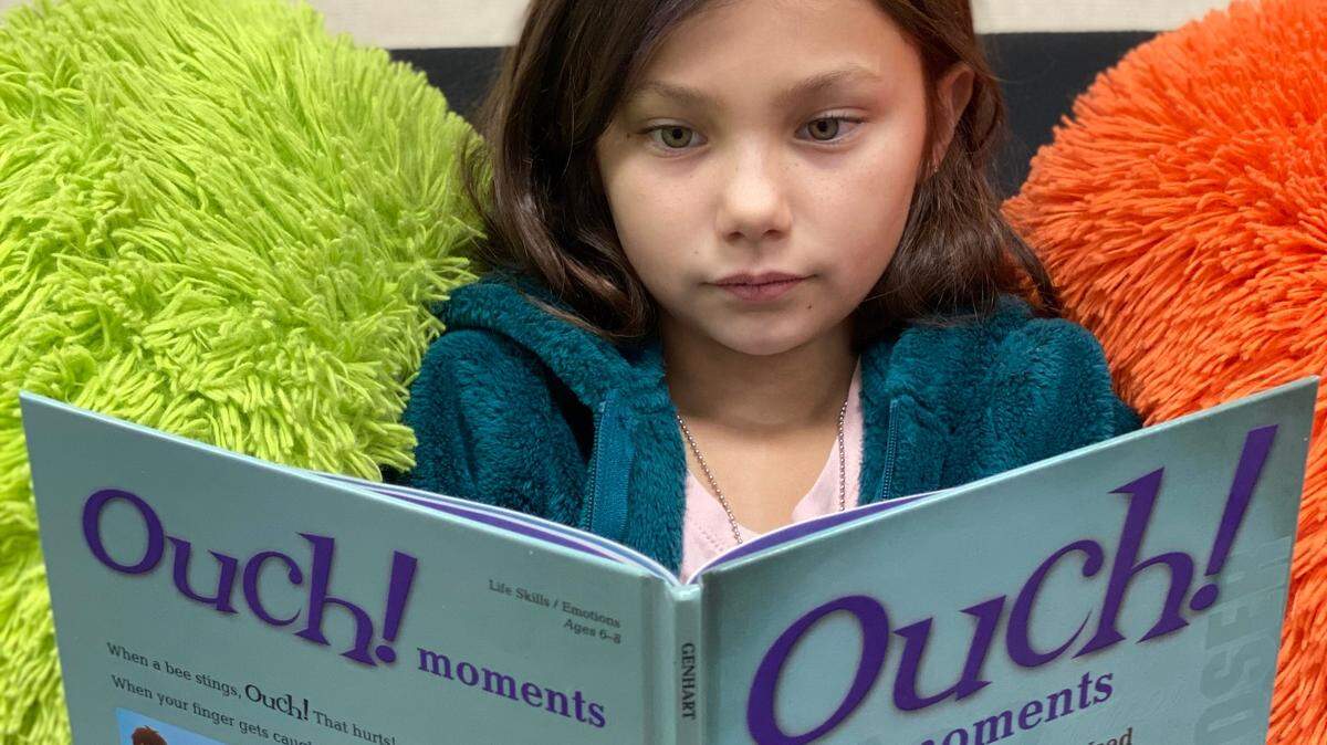 A Turlock Unified grade-schooler reads a book from the school district’s social-emotional curriculum. The book is titled ‘Ouch moments: When Words are Used in Hurtful Ways.’