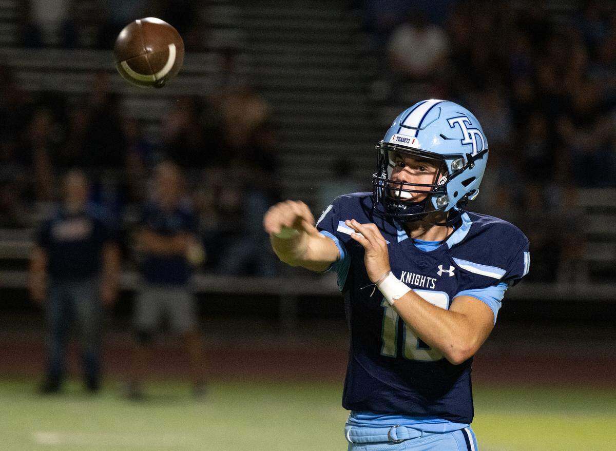 Downey quarterback Carson Lamb makes a pass during the non-league game with Amador Valley at Downey High School in Modesto, Calif., Friday, Sept. 13, 2024.