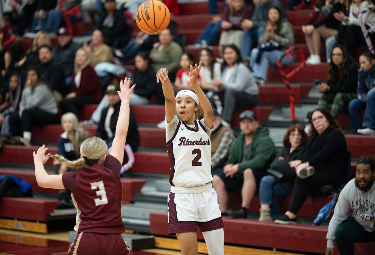 Riverbank’s Taylor Macias scores 3 of her 23 points in the Mother Lode League game with Calaveras in Riverbank, Friday, Jan. 31, 2025.