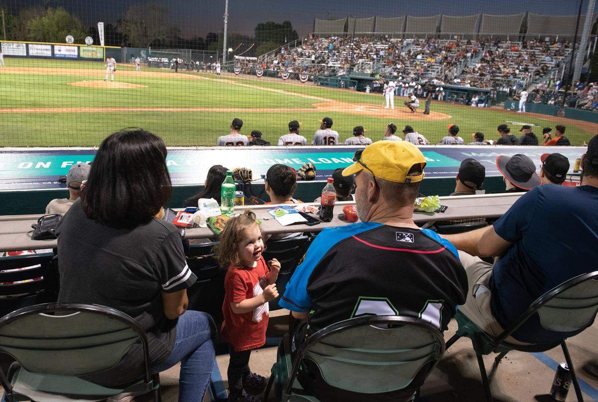 Don and Jennie Clark enjoy opening day of baseball with their granddaughter Brooke, 2, as they watch the Modesto Nuts and San Jose Giants play at John Thurman Field in Modesto, Calif., on Friday, April 8, 2022. Modesto won the game 5-3.