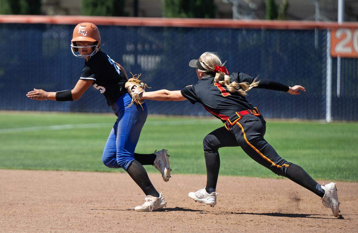 Oakdale’s Jayci Volonte (1) tags out Capital Christian runner Abby Rhee during the Sac-Joaquin Section D III softball championship game with Capital Christian at Cosumnes River College in Sacramento, Calif., Saturday, May 25, 2024.