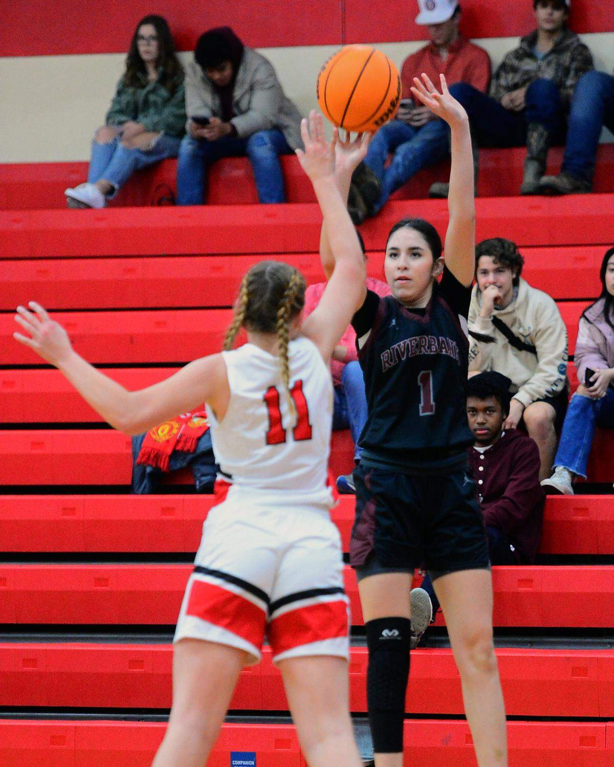 Riverbank guard Livi Fernandez (1) shoots a three during a game between Ripon High School and Riverbank High School at Ripon High School in Ripon, Calif. on January 5, 2023.
