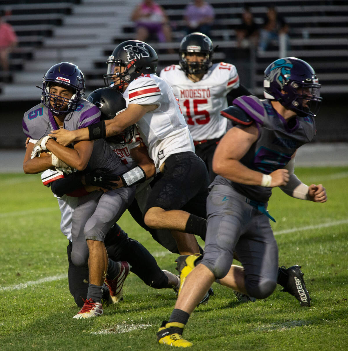 Khushmehakpreet Bains, 5, of Johansen High gets wrapped by the Modesto Panther defense Friday August 19, 2022.