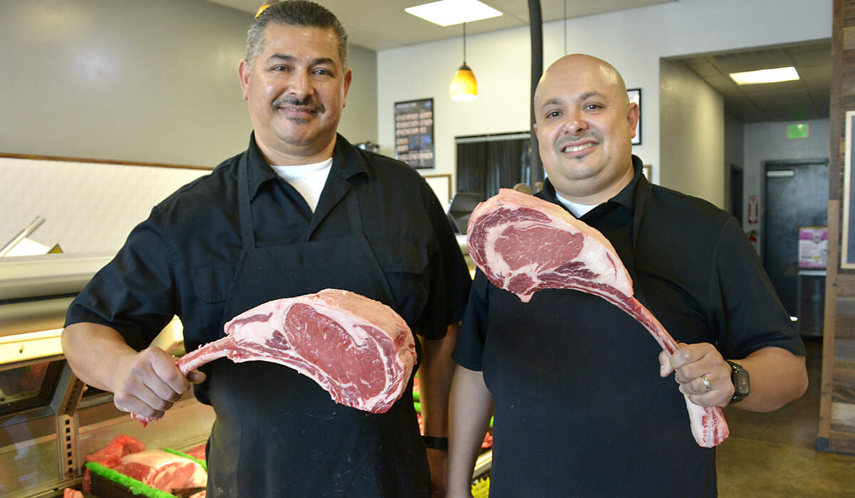 Carlos Virgen (left) and his nephew Sal Virgen inside their new store Chuck’s Butcher Shop in Hughson, Calif.