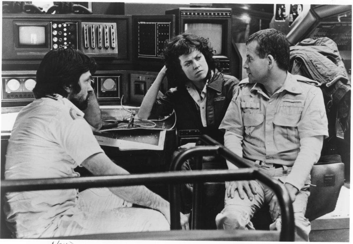In “ Alien “, a group of men and women who haul precious minerals and resources from outer space are rudely awakened from their “frozen” state of slumber by a distress beacon from an unknown source. Soon they learn that the cargo they are bringing back to earth contains more then they bargained for: an Alien. Stars Tom Skerritt (left0, Sigourney Weaver (Center), Ian Holm (Right)
