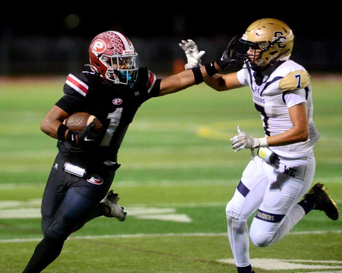 Patterson running back Jeremiah Lugo (1) stiff arms a Central Catholic defender during a game between Central Catholic High School and Patterson High School at Patterson High School in Patterson California on September 9, 2024. Central Catholic won the game 25-14