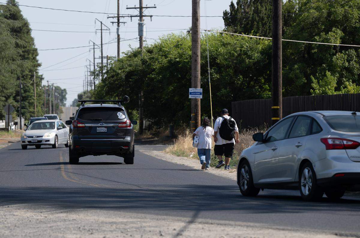 Pedestrians walk down Golf Road west just west of Golden State Bouldvard in Turlock, Wednesday, June 4, 2025. 