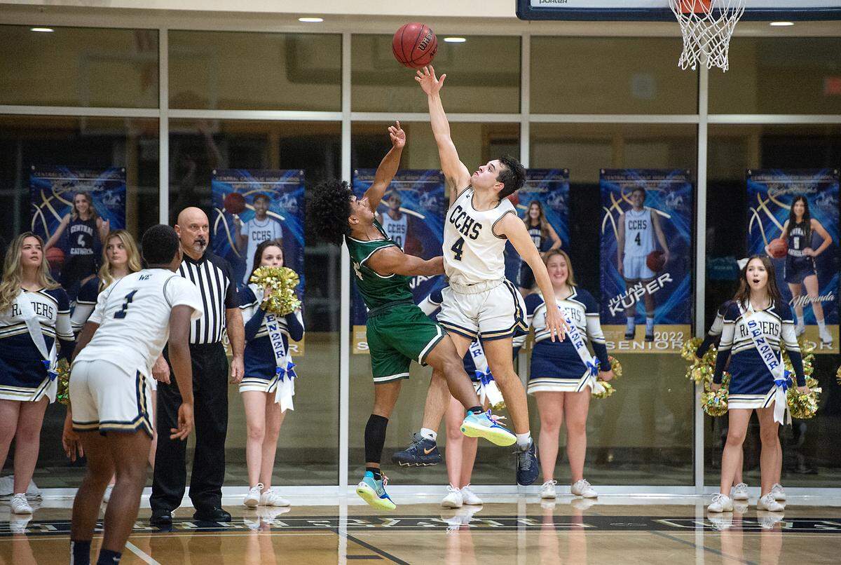 Central Catholic’s Arthur Avila contests the shot of Manteca’s Trey Moreland during the Valley Oak League game at Central Catholic High School in Modesto, Calif., on Wednesday, Feb. 9, 2022. Manteca won the game 39-33.