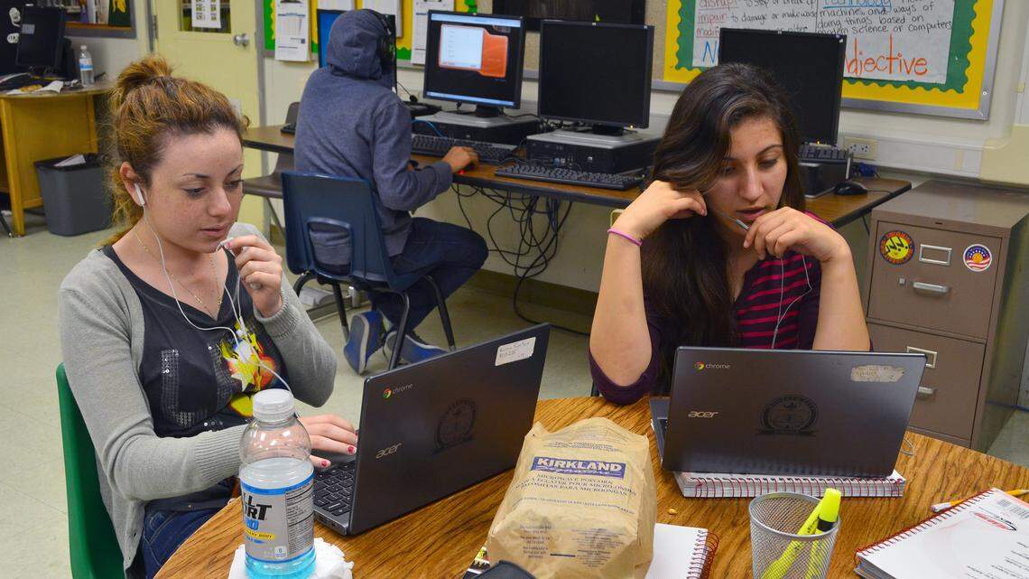 In this photo from May 2015, Language Institute students Karen Rios, left, and Maribel Munoz practice speaking English words into an online program.