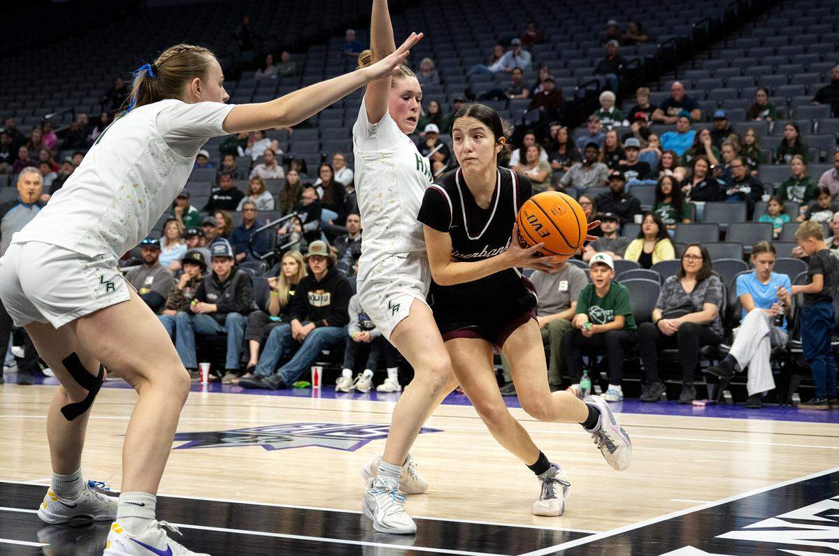 Riverbank’s Alexis Felix advances towards the basket defended by Liberty Ranch players Kamrynn Blevins, middle, and Kendall Duryee, left, during the Sac-Joaquin Section Division IV championship game at the Golden 1 Center on Thursday.