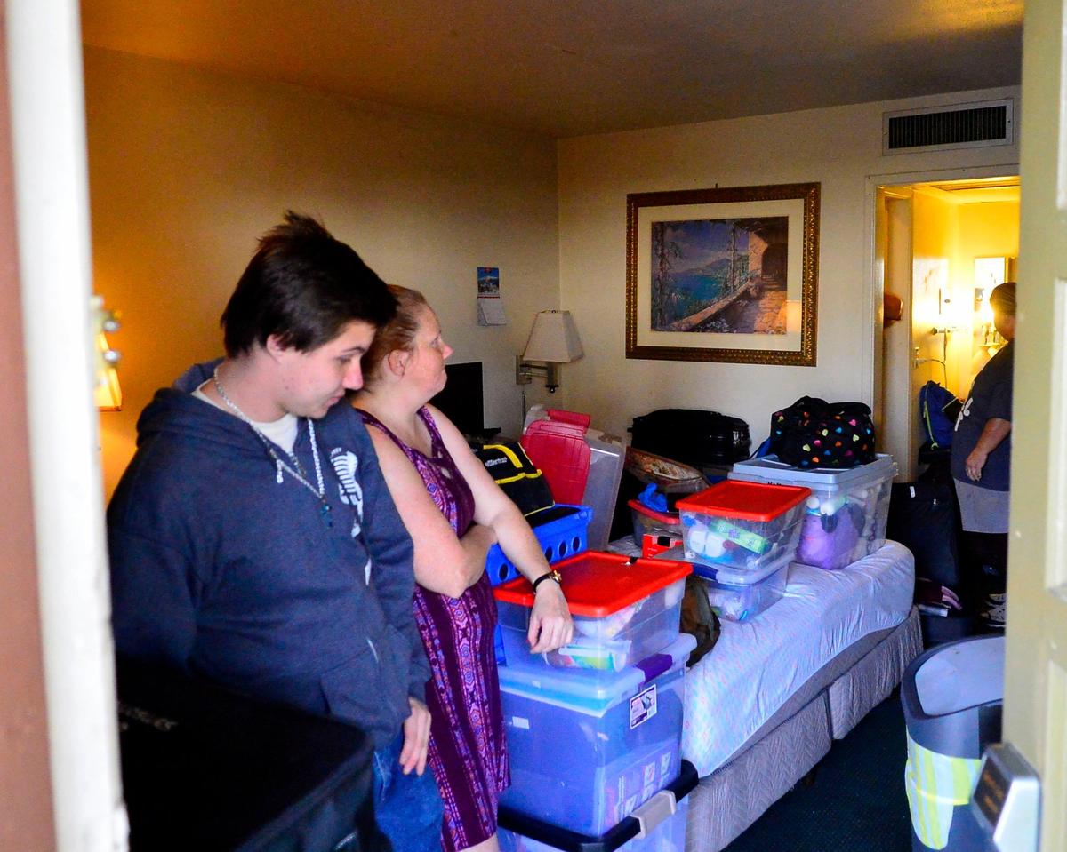The Hayes family, including Aerik (left) and Anita (center) vacate the Budgetel Inn & Suites on McHenry ave after being evicted by the hotel due to the business’s closure on January 26, 2019 in Modesto California.