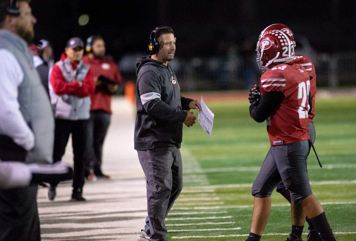 Patterson coach Rob Cozart talks with players during a Sac-Joaquin Section Division III semifinal with Grant in Patterson, Calif., Friday, Nov. 18, 2022.