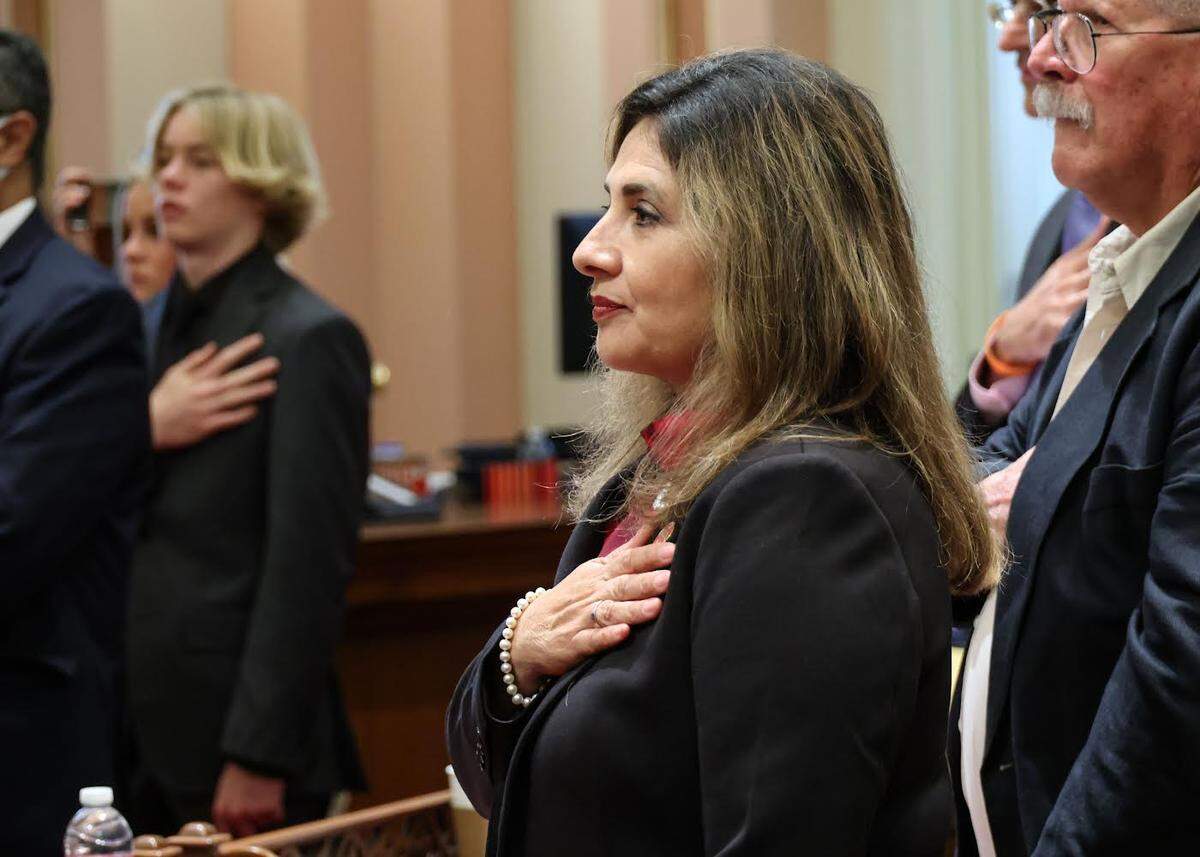 Marie Alvarado-Gil is sworn in Dec. 5, 2022 as a state senator at the Capitol in Sacramento. She represents Stanislaus and 12 other counties. Behind her is Bruce Farrell, her adoptive father.