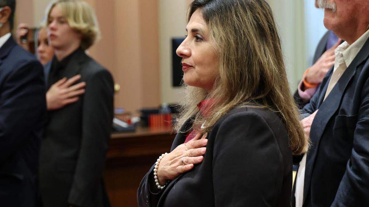 Marie Alvarado-Gil is sworn in Dec. 5, 2022 as a state senator at the Capitol in Sacramento. She represents Stanislaus and 12 other counties. Behind her is Bruce Farrell, her adoptive father.