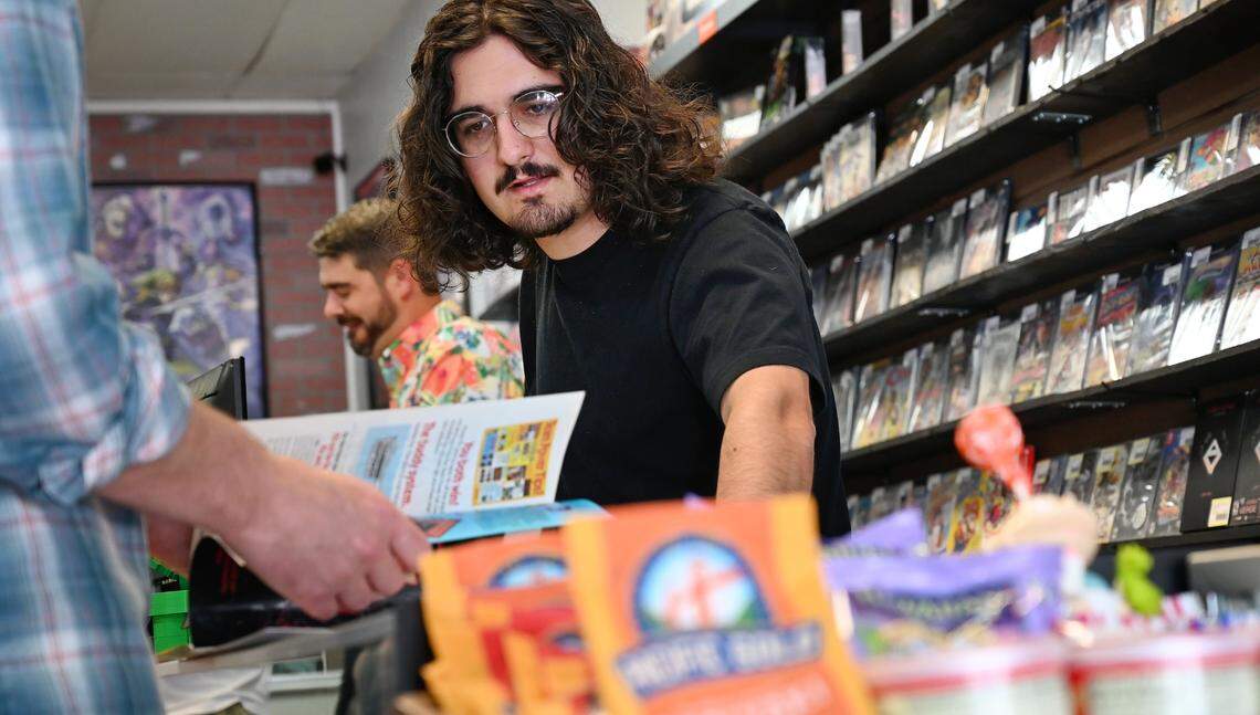 Jace Pimentel helps a customer at Laughing Crow Collectibles in Modesto, Calif., Thursday, May 2, 2024.