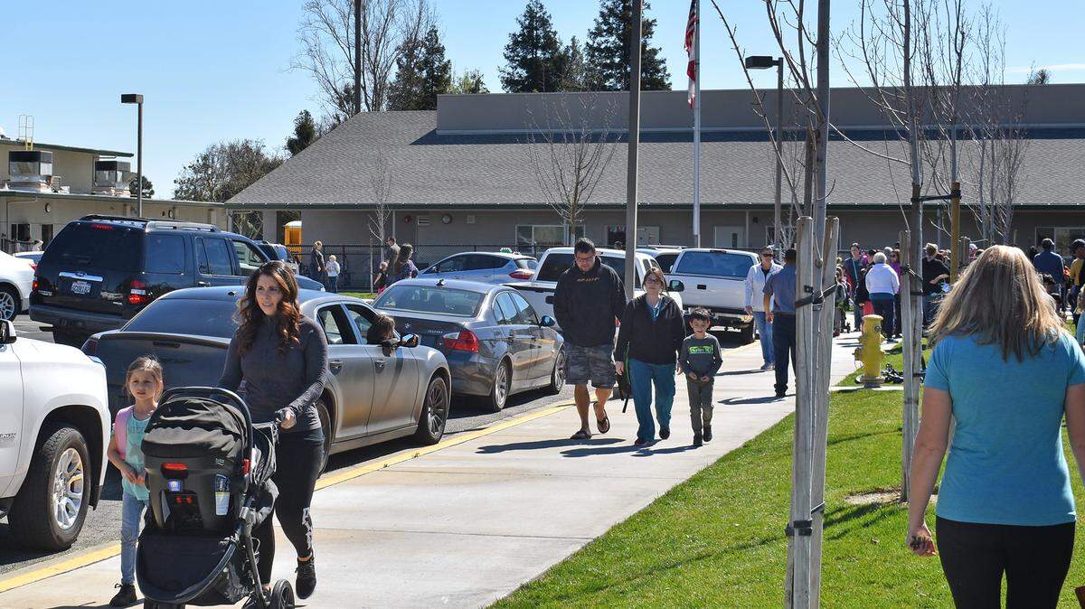 Parents pick up their children after school at Weston Elementary in Ripon, CA, on Thursday, March 14, 2019. Ripon Unified School District is working with Sprint to move a cellular phone tower, seen in the center background, after four students were diagnosed with cancer and parents voiced their concerns.