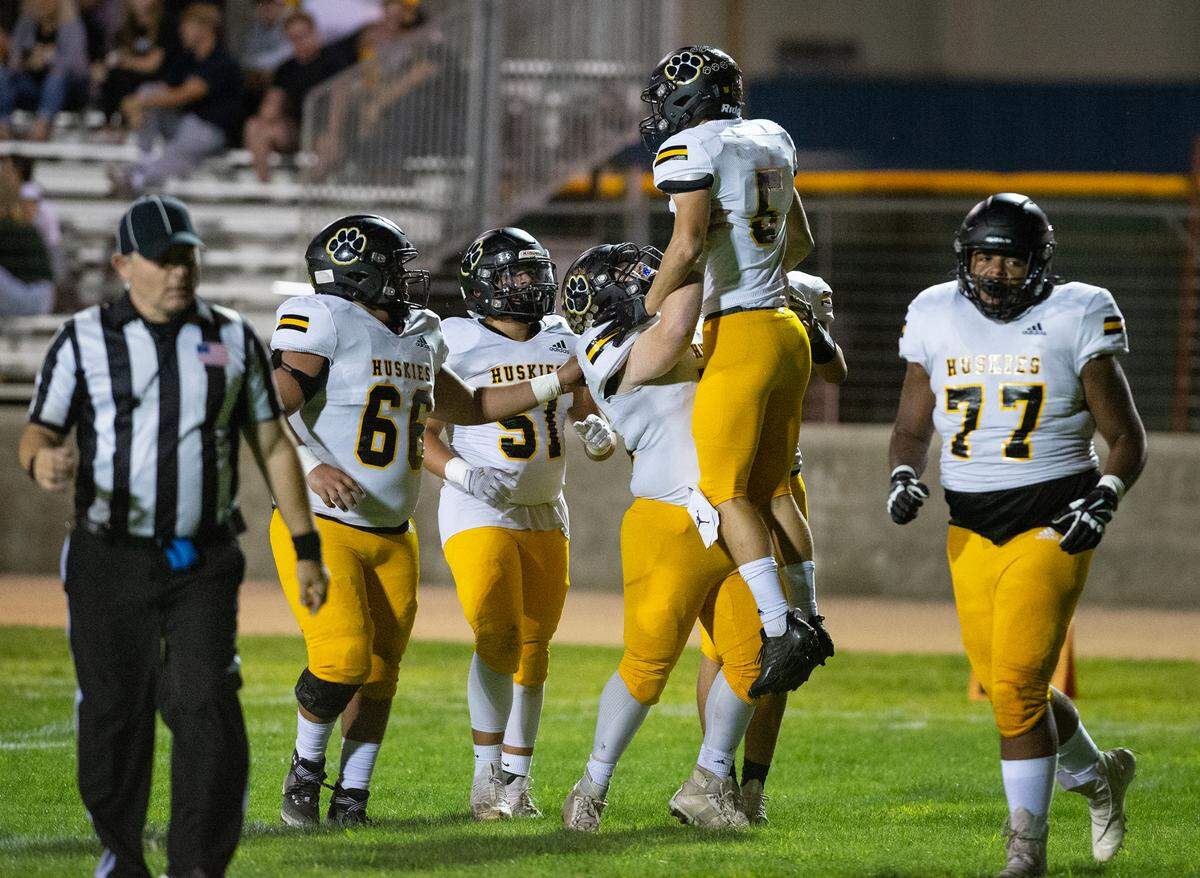 Hughson players celebrate a touchdown reception during the Trans Valley League game with Modesto Christian at Modesto Christian High School in Salida, Calif., Thursday, September 29, 2022.