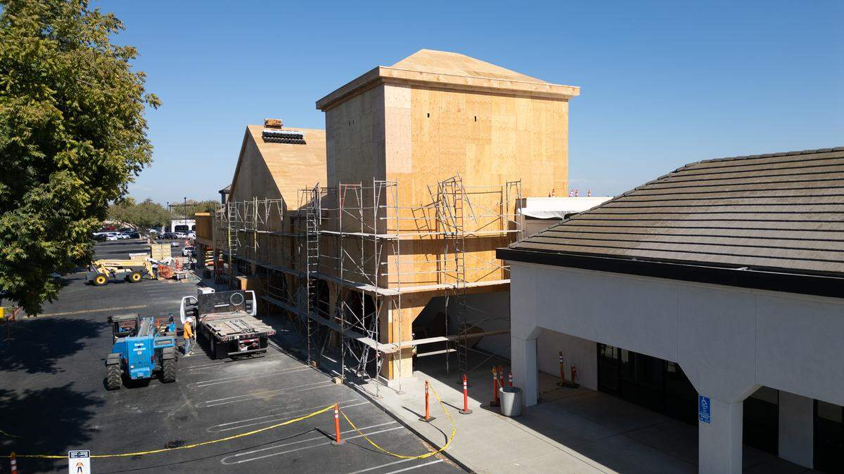 A crew works on the exterior of Wood Colony Plaza on Pelandale Avenue in Modesto, Calif., Tuesday Oct. 8, 2024.