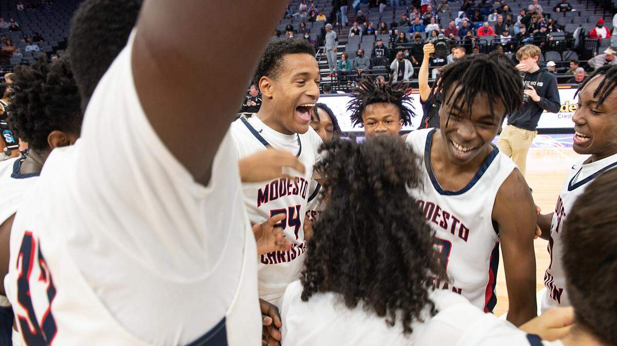 Modesto Christian players celebrate their 52-42 victory over Sheldon in the Sac-Joaquin Section Division 1 boys basketball championship at the Golden 1 Center in Sacramento, Calif., on Saturday, Feb. 26, 2022.