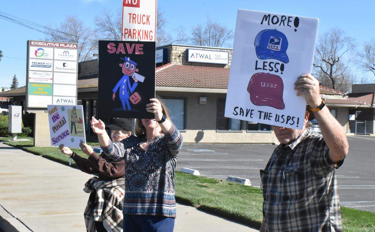 From left, Ann Nicastro, Jeanine Bean and David Bean rally in support of U.S. Postal Service workers along Mitchell Road in Ceres on Sunday, March 23, 2025.