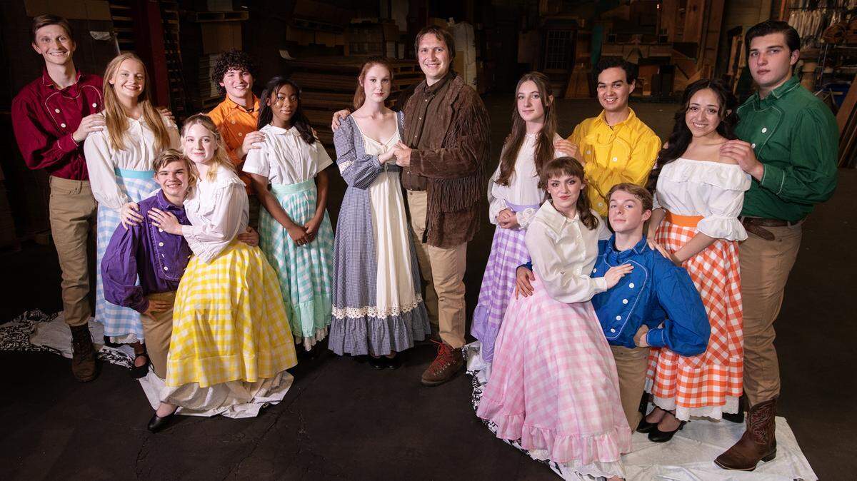 The cast of the Modesto Performing Arts production of “Seven Brides for Seven Brothers” at their rehearsal space in Modesto, Calif., on Saturday, July 30, 2022. Performers from the left, Jarod Honberger, Morgan Hildebrandt, John Sylvester, Megan Tallcott, Ziggie Garcia, Dzifa Ackuayi, Carma Mize, Shawn Soelberg, Cadence Tallcott, Eric Rosales, Elena Lopez, Spencer Brown, Izabella Duran-Soriano and Levi Johannsen.