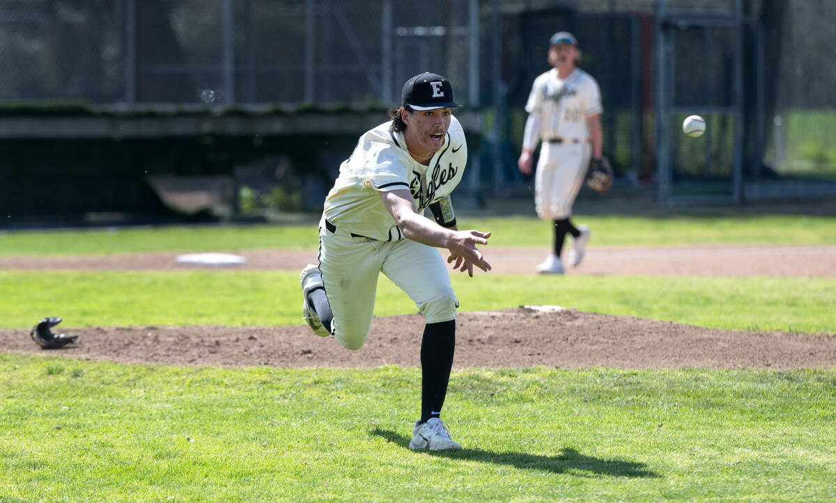 Enochs pitcher Michael Day flips the ball to first after being knocked down by a line drive during the March Madness baseball tournament game with Turlock in Modesto, Calif., Friday, March 8, 2024.