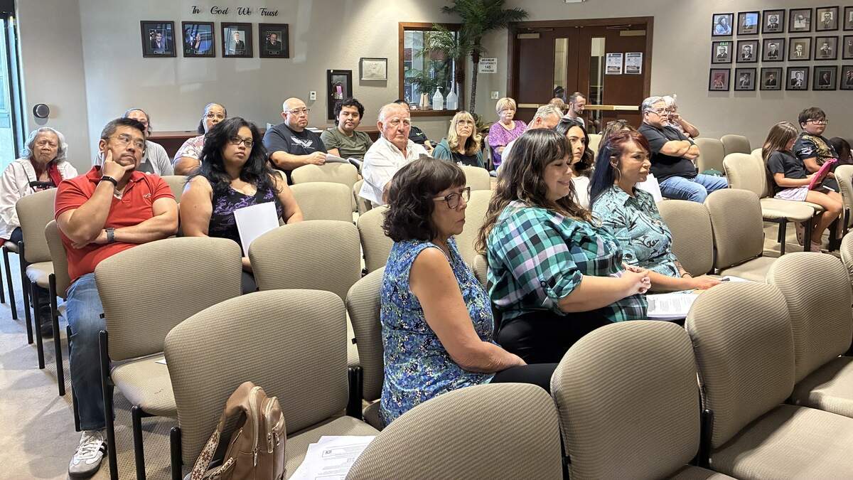 Residents sit in chairs looking forward towards the Patterson city dias.