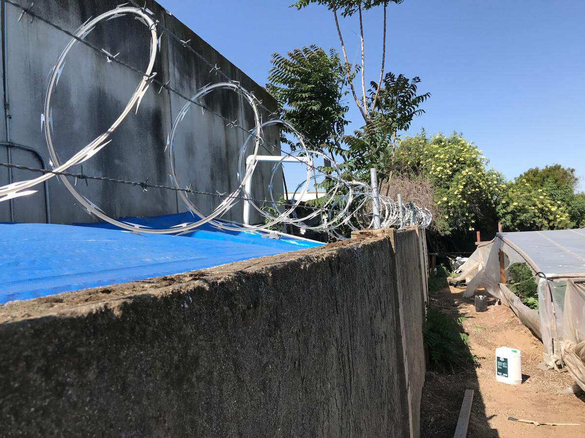 A man fleeing authorities scaled this fence during a raid on an illegal marijuana grow on Olivera Road in south Modesto on Thursday, April 28, 2022.